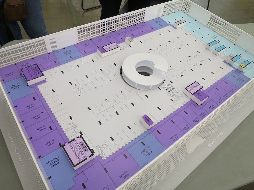 Diagram model of the sixth floor with the up-spiral access ramp (centre), parking (grey), residential units (purple), and office space (blue).!